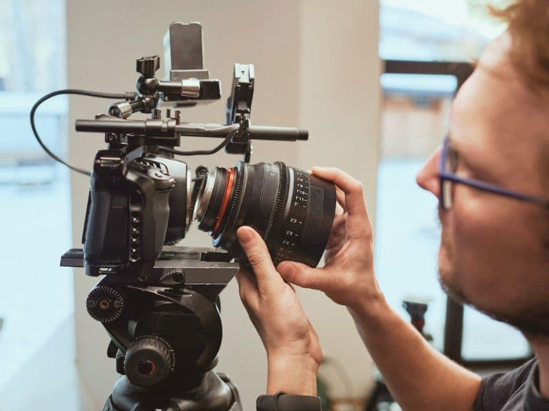 Wedding videographer filming a ceremony — cinematic documentary style
